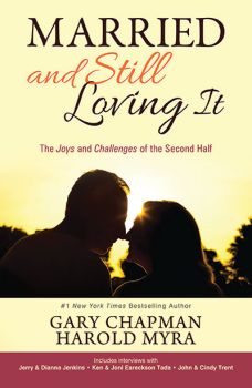 The cover of the book 'Married and Still Loving It' featuring the silhouette of a couple kissing at sunset.