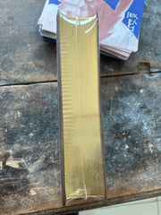Gold-colored metal strip on a worn wooden surface